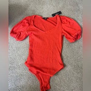 Bright orange bodysuit with bell sleeves